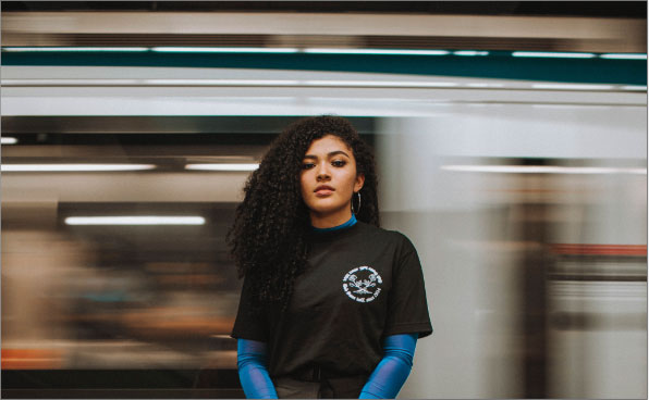 woman's headshot by moving subway lights